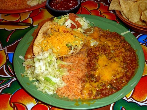 Doug's Cheese Enchilada under a Chile Meat Sauce, Crispy Beef Taco, Chili Rellano, Rice and Beans