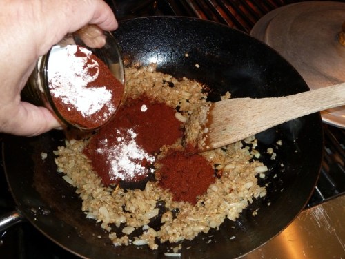 Add chile powder and flour — stir until thick