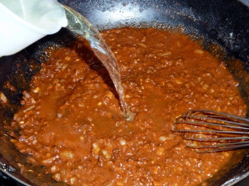 Slowly add the stock, whisking continuously as you do