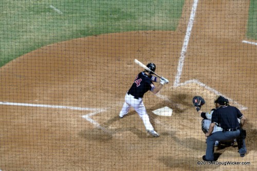 Keep one eye in the viewfinder and the other on the pitcher