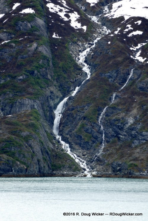 Waterfall cascading into Glacier Bay